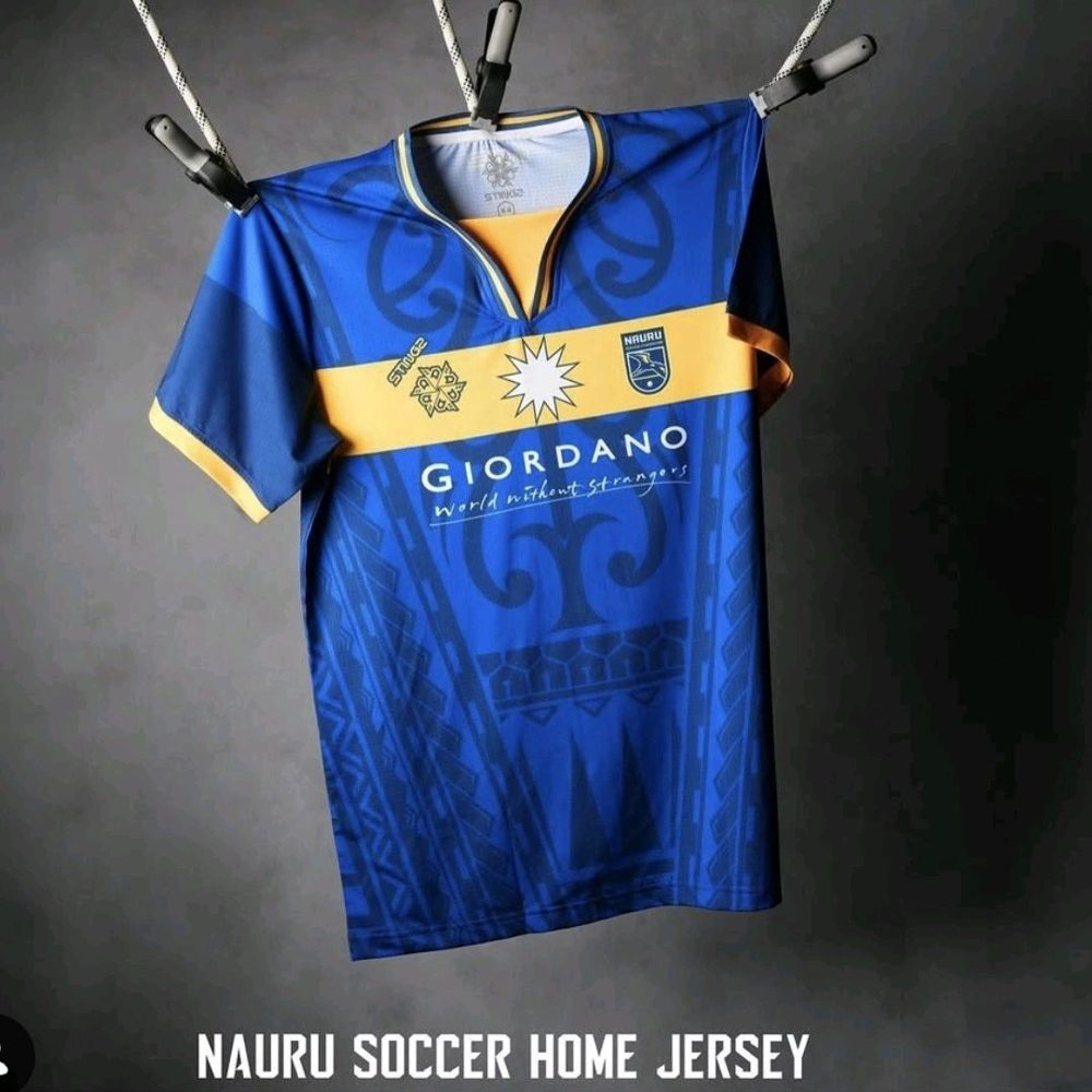 The blue Naoero home jersey with gold chest band hanging from a line