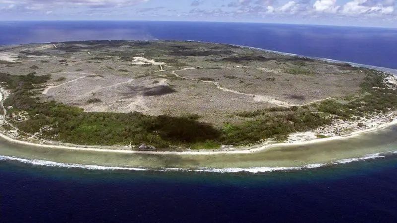 Aerial view of Nauru: the mined interior plateau ringed by a green coastal strip and reef
